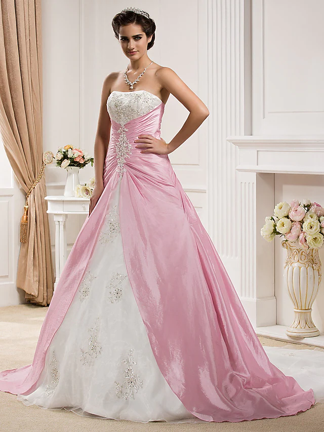 Elegant bridal portrait featuring a strapless ball gown wedding dress.