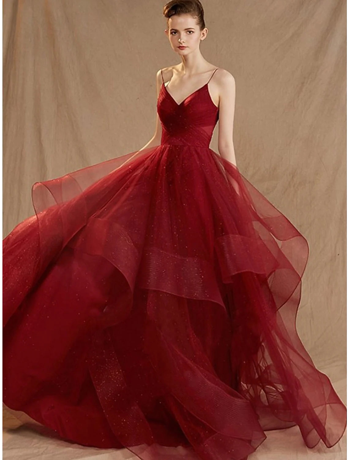 Side view of a sleeveless V-neck formal dress with sequin details.