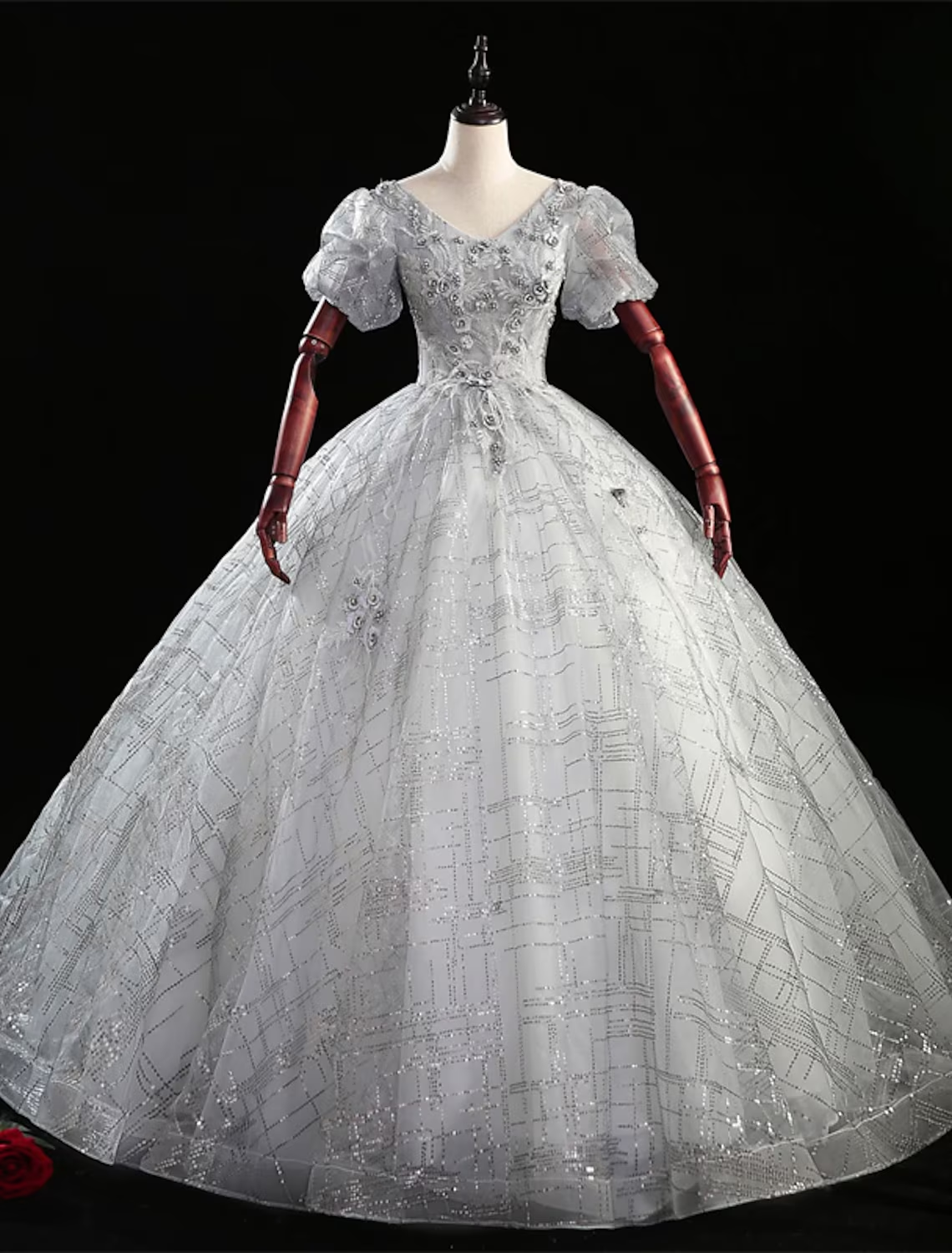 Elegant ball gown Quinceanera dress with V-neck and short sleeves, adorned with beading.