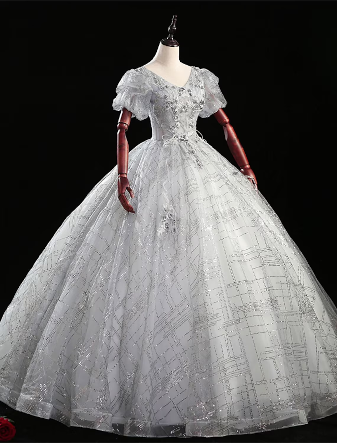 Close-up of the V-neckline and intricate beading on the Quinceanera dress.