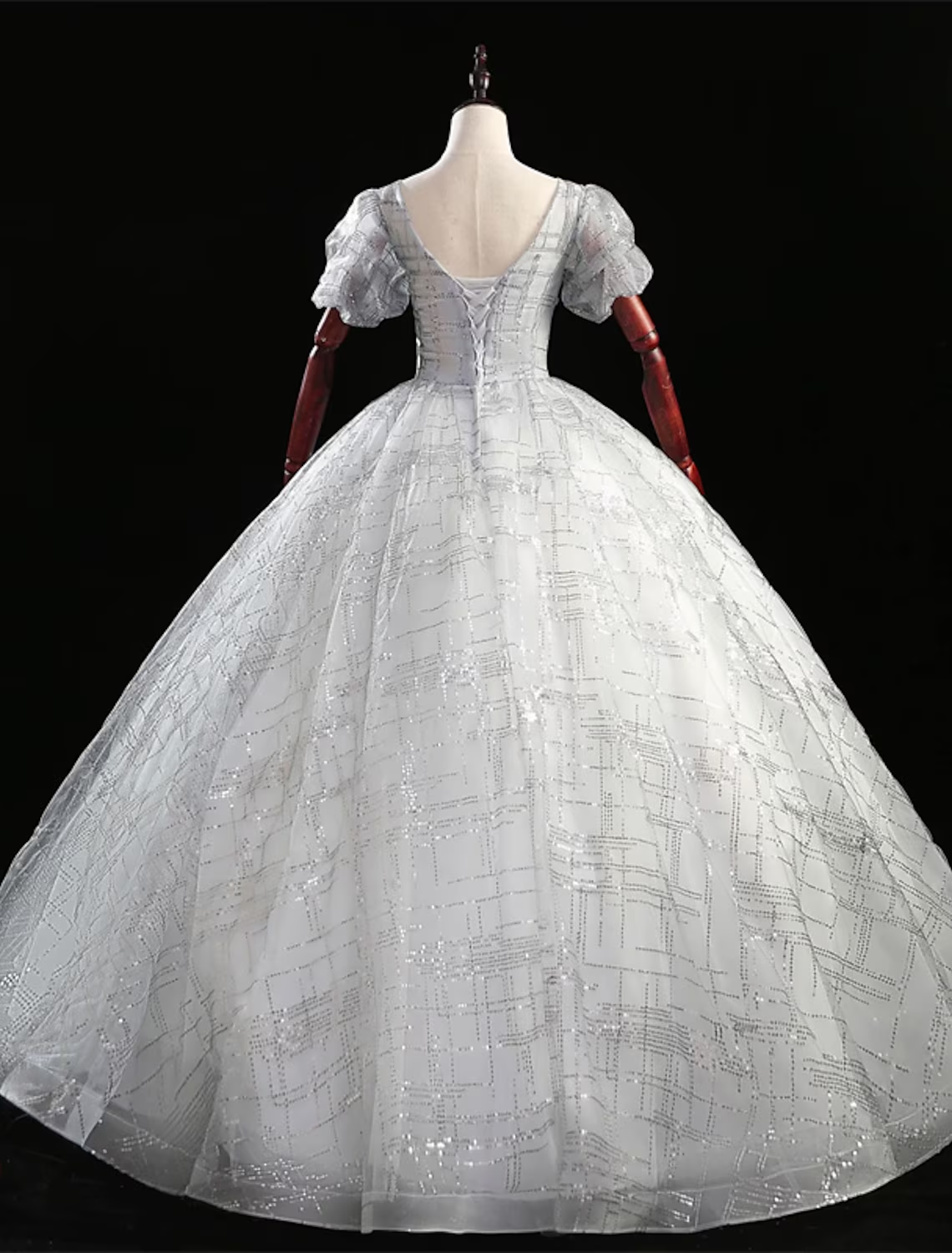 Side view of the princess-style Quinceanera dress, highlighting the short sleeves and flowing skirt.