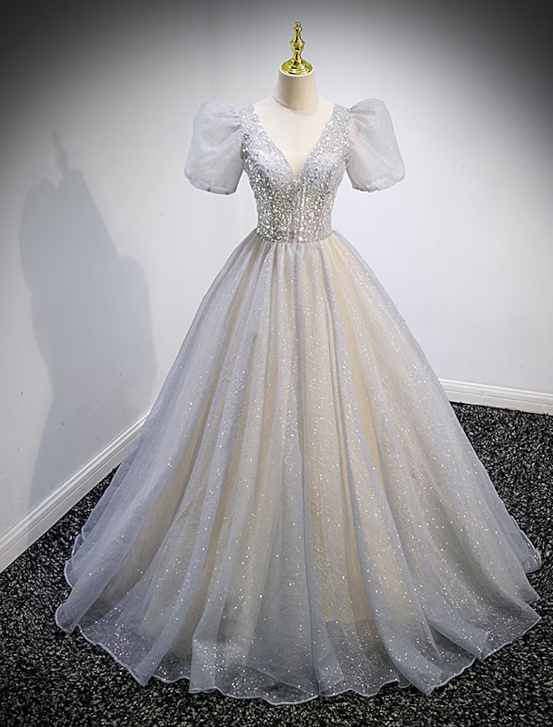 Elegant V-neck short sleeve ball gown Quinceanera dress with crystal embellishments and sweep train.