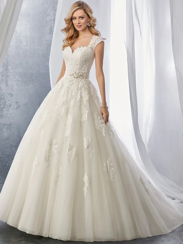 Elegant ball gown wedding dress with sweetheart neckline and chapel train.
