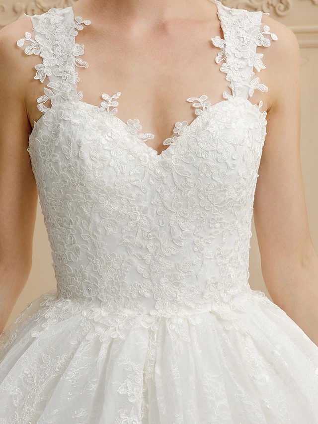 Detail of the all-over lace on the wedding dress skirt.
