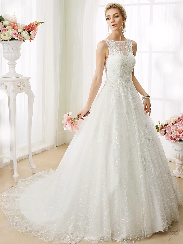 Elegant ball gown wedding dress with bateau neckline and full skirt.
