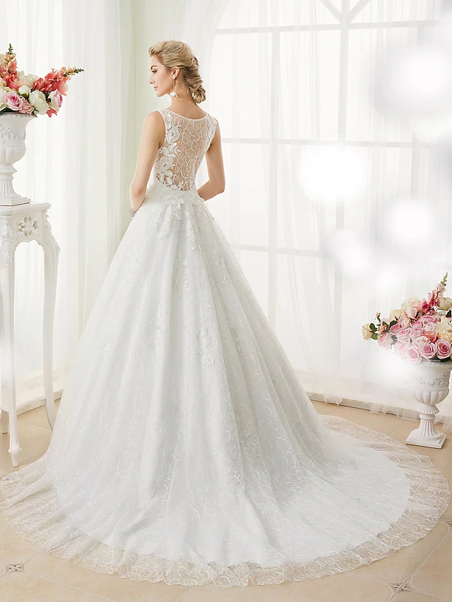 Back view of wedding dress showing sheer lace and applique details.