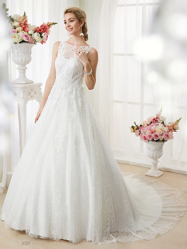 Close-up of beaded lace bodice and bateau neck on bridal gown.
