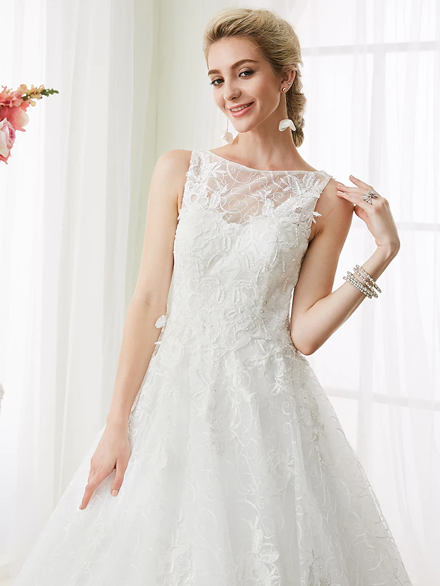 Detail of intricate lace and beading on the wedding dress skirt.
