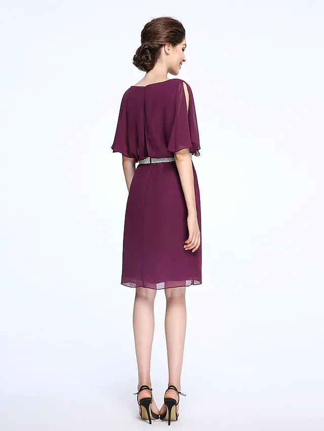 Side view of a woman wearing a knee-length chiffon Mother of the Bride dress.