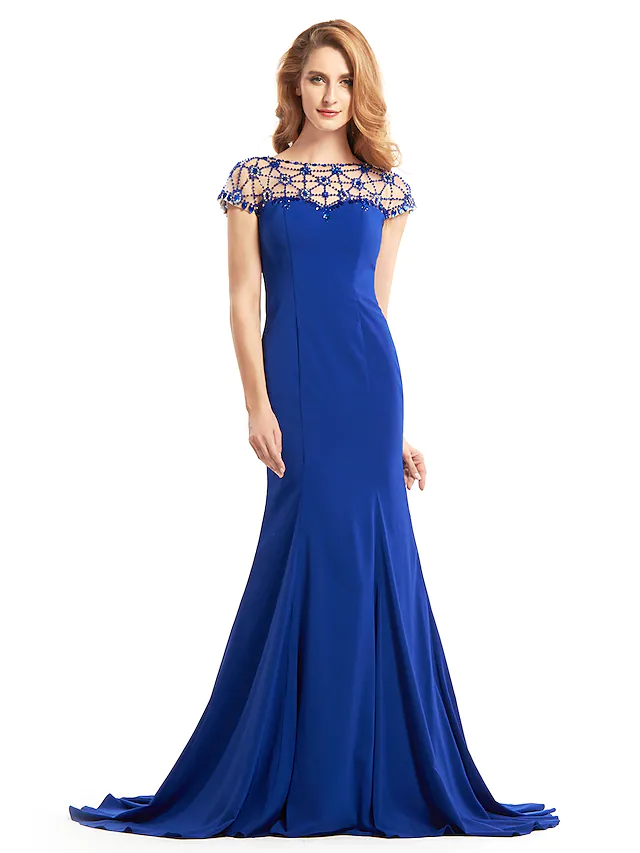 Woman in elegant purple Mother of the Bride dress with bateau neck.