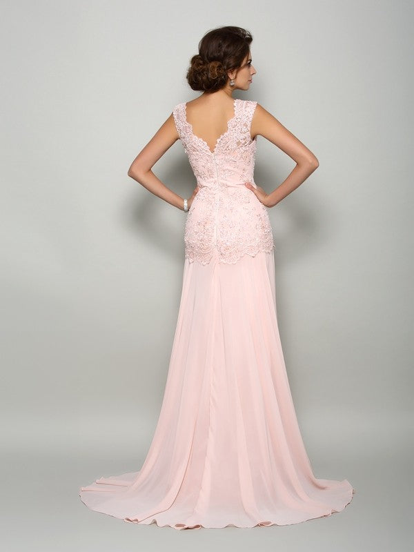 Back view of a long pink chiffon mother of the bride dress with delicate beading.