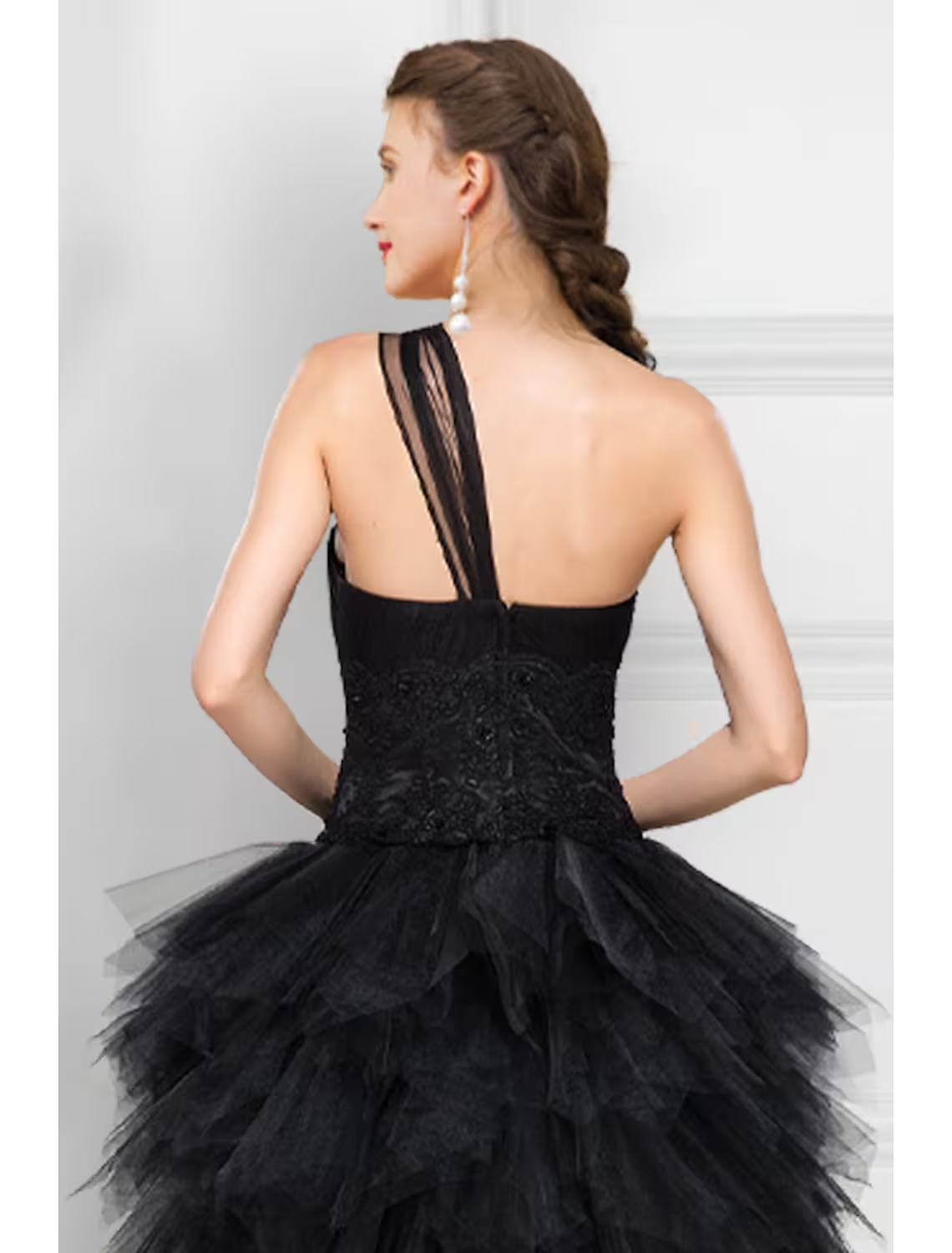 Back view of a black ball gown showing the ladder back detail.