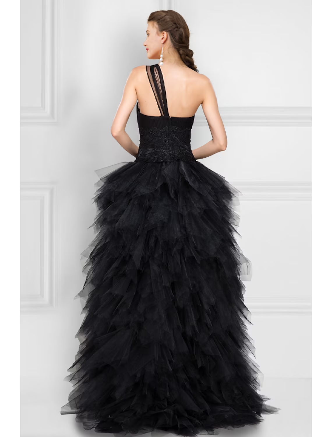 Close-up of the black one-shoulder neckline and tulle fabric of the gown.