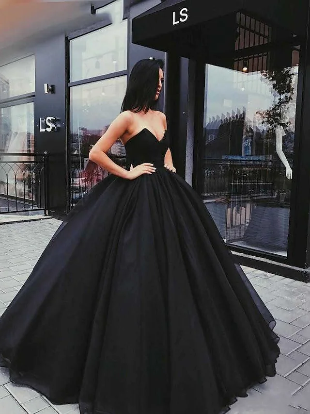Side view of the black ball gown wedding dress, showing draped organza and satin skirt.