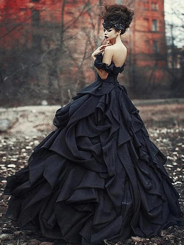 Side view of black off-shoulder wedding dress with court train.