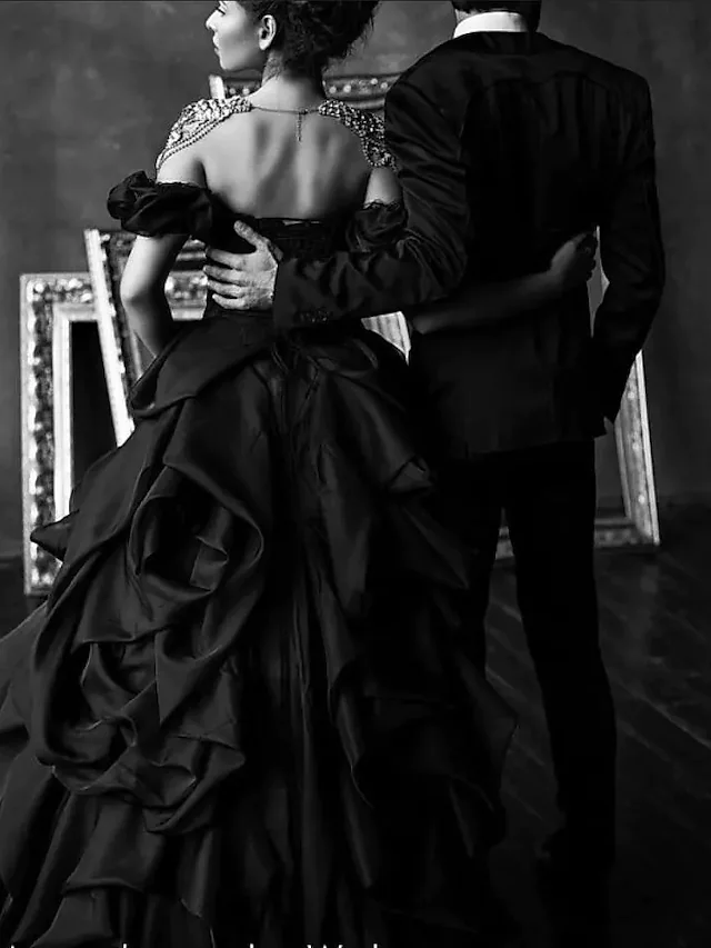 Back view of black lace tulle ball gown with cascading ruffles.