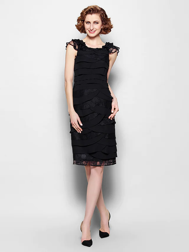 Elegant black sheath dress with scoop neck, lace details, and ruffles, front view.