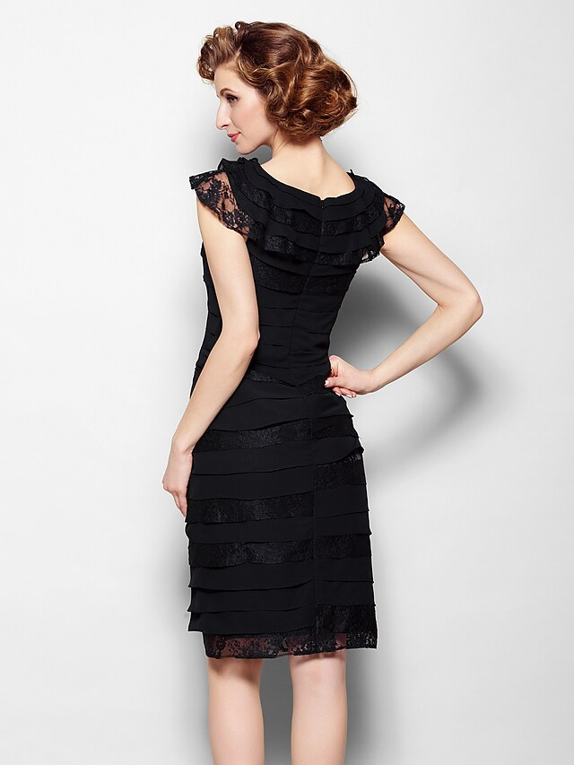 Model wearing the black mother of the bride dress, showcasing its knee-length.
