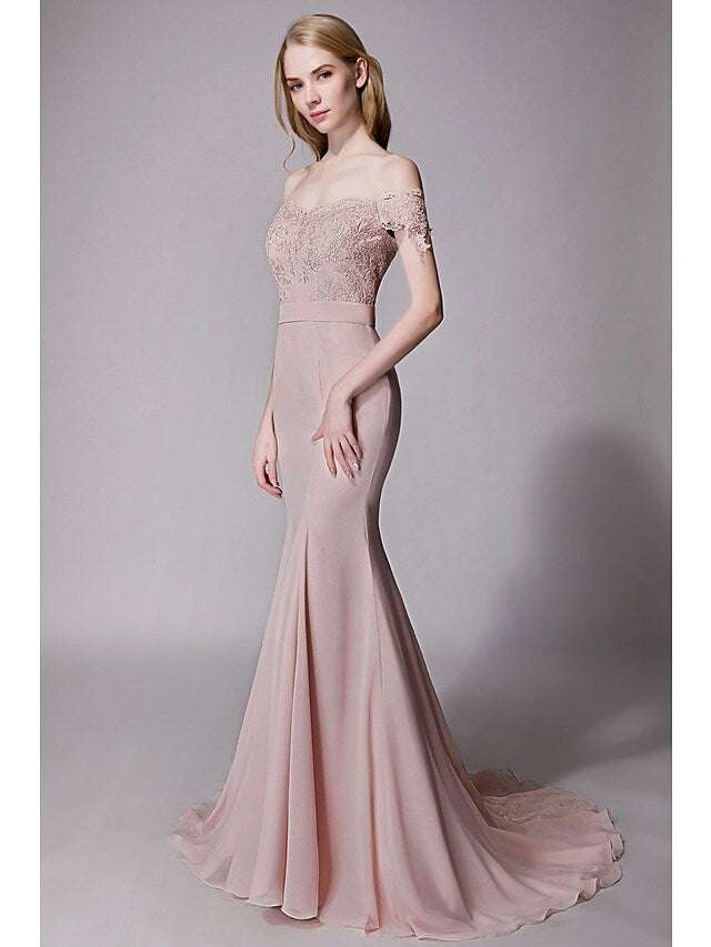 Back view of a bridesmaid gown showcasing a court train and delicate lace sash.