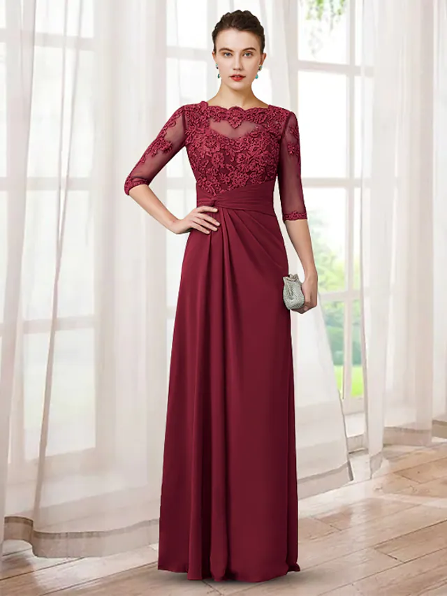 Front view of an elegant chiffon lace Mother of the Bride dress with jewel neck, half sleeves, appliques, and ruching.