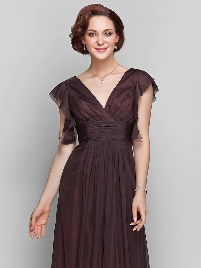 Close-up of the V-neckline and short sleeve on the formal dress.