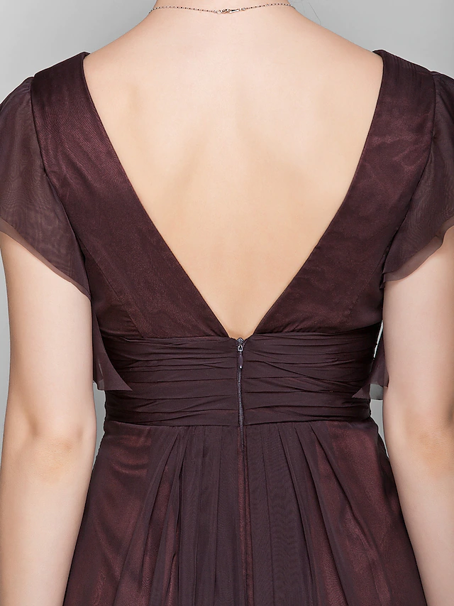 Woman wearing a floor-length V-neck chiffon Mother of the Bride dress.