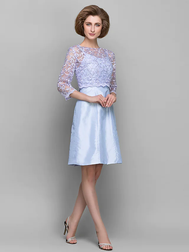Elegant knee-length sheath dress with bateau neck and 3/4 lace sleeves.