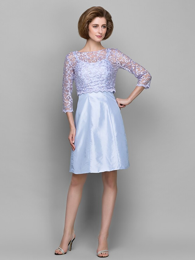 Side profile of the knee-length lace taffeta dress.