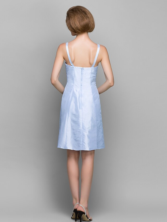 Woman modeling the versatile sheath dress for a special occasion.
