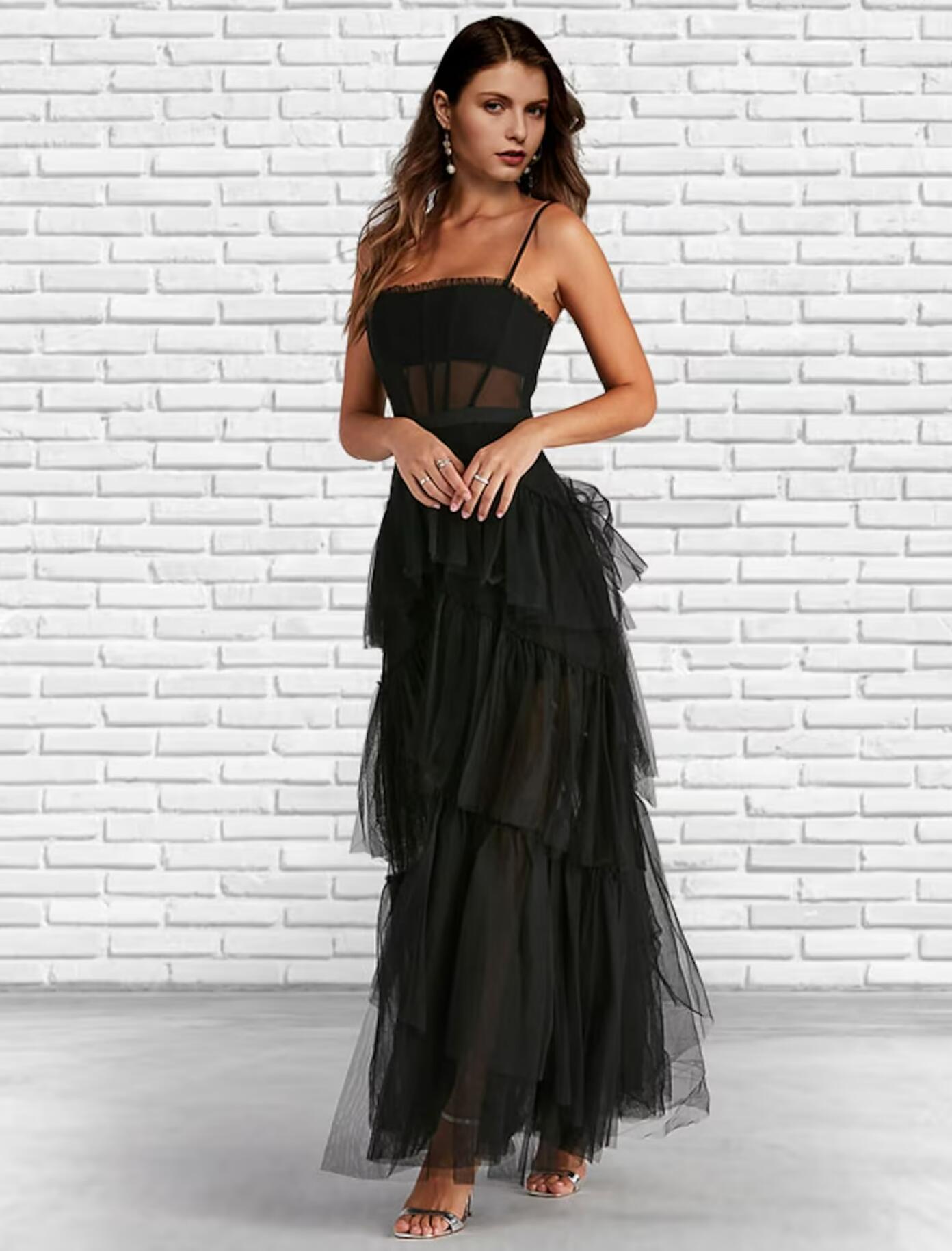 Elegant strapless tulle prom dress with corset bodice and ruffles.
