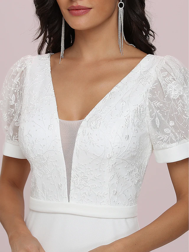 Close-up of the V-neck and off-shoulder bodice with short sleeves on the bridal gown.