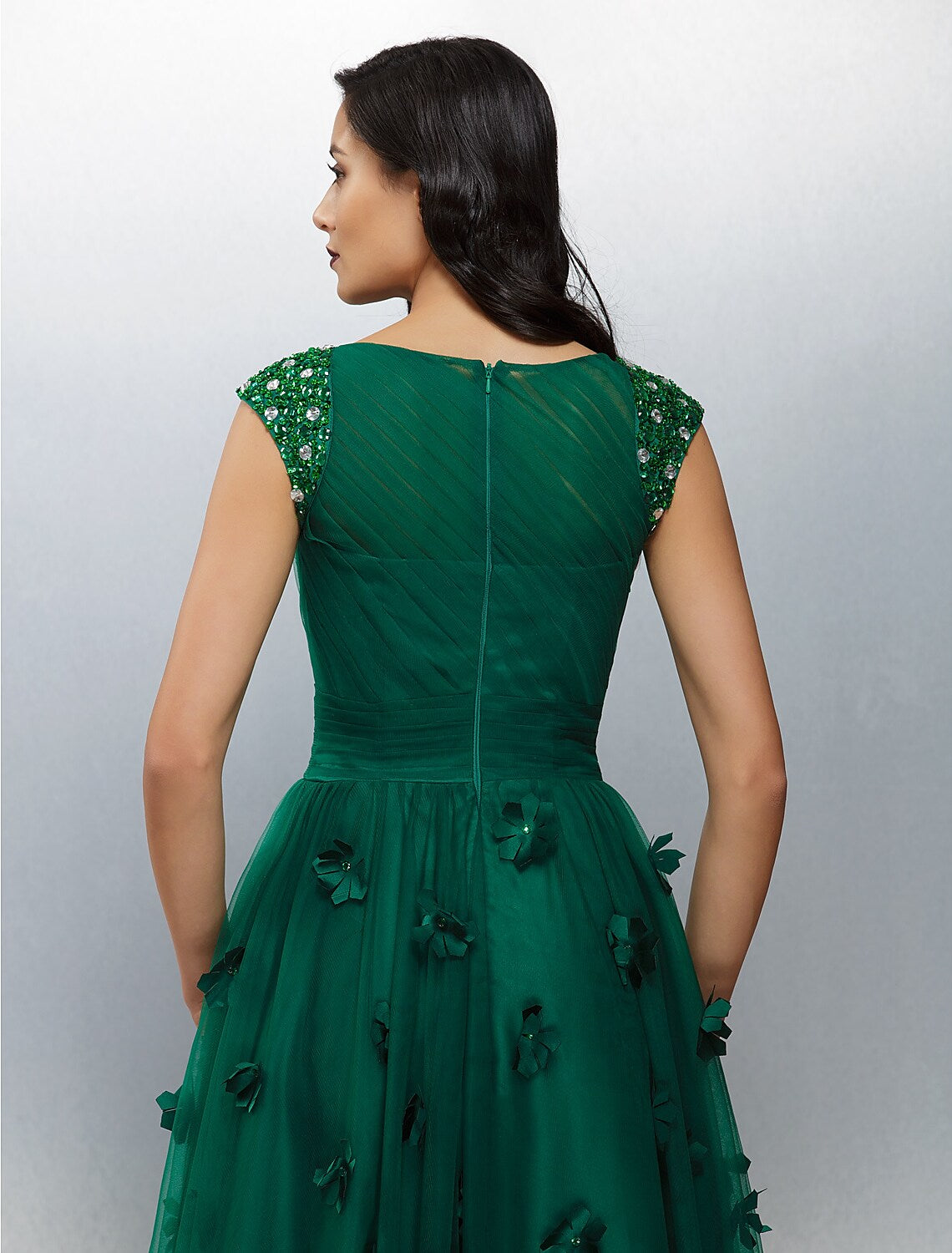 Side profile of the floral wedding guest dress with short sleeves.