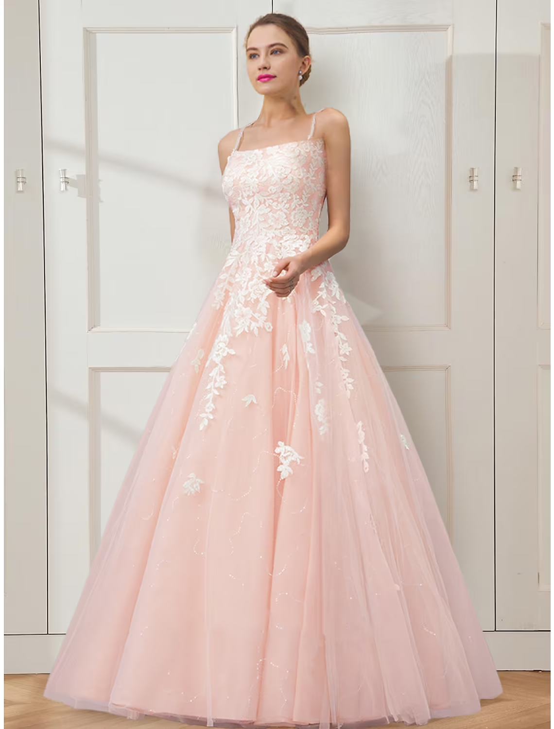 Elegant floral embroidered ball gown prom dress with spaghetti straps and a full tulle skirt.