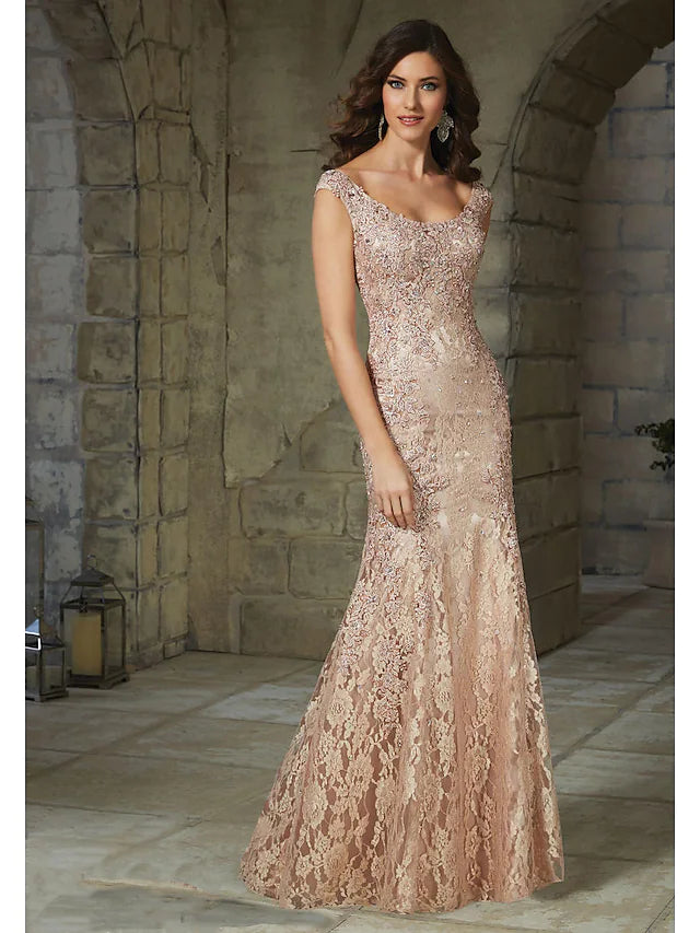Woman wearing an elegant floral lace mermaid trumpet evening gown.