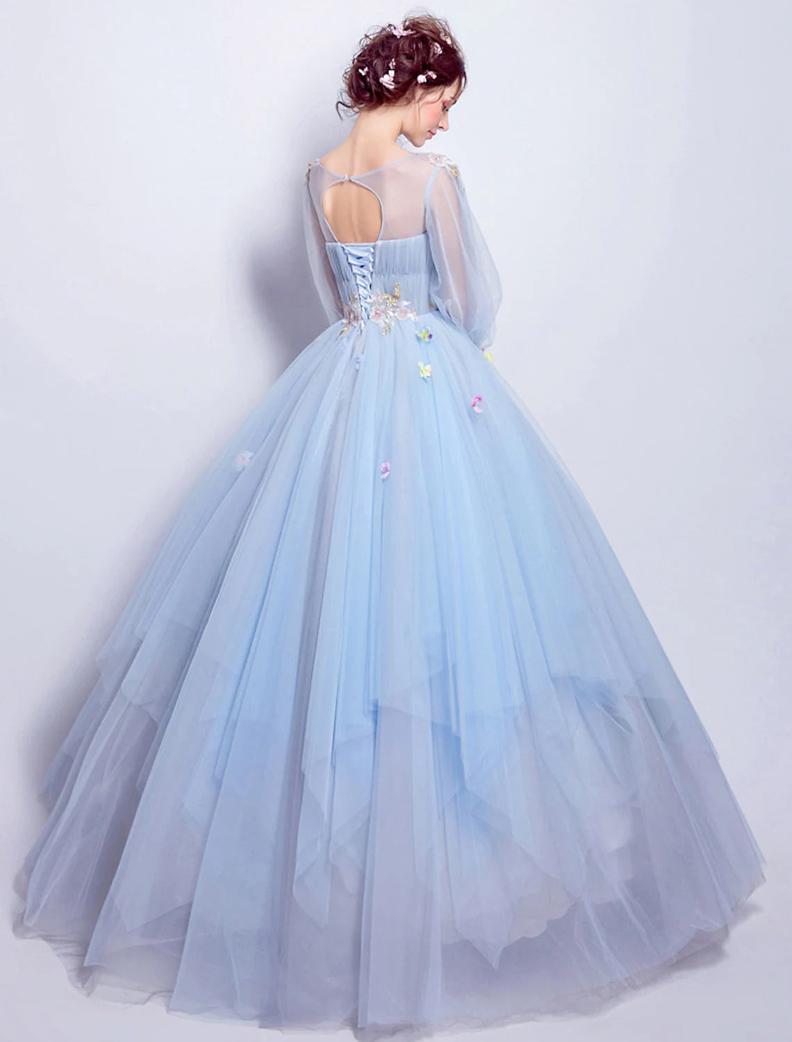 Close-up of illusion neckline and 3/4 sleeve on floral ball gown.