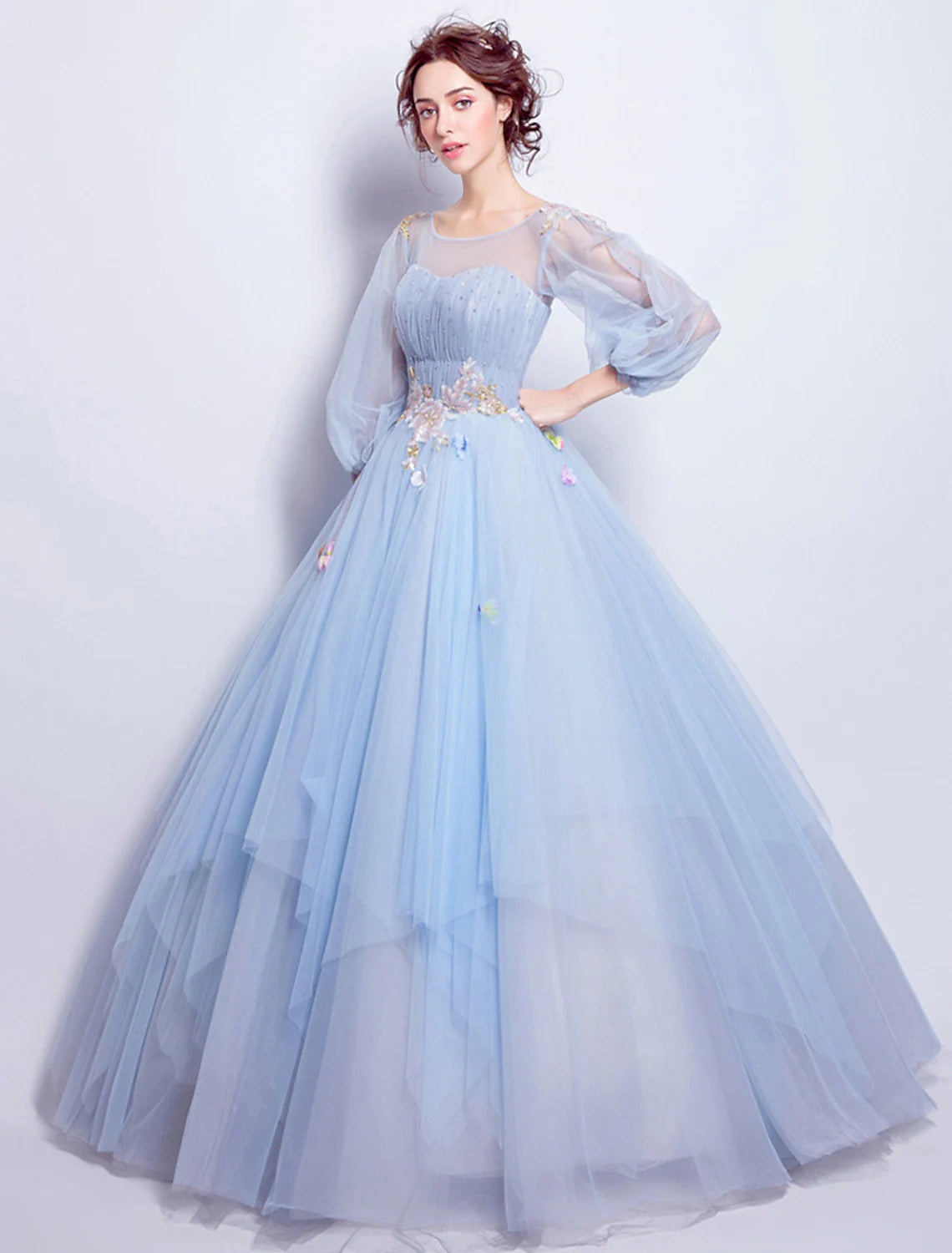 Full view of model posing in a floor-length engagement ball gown.