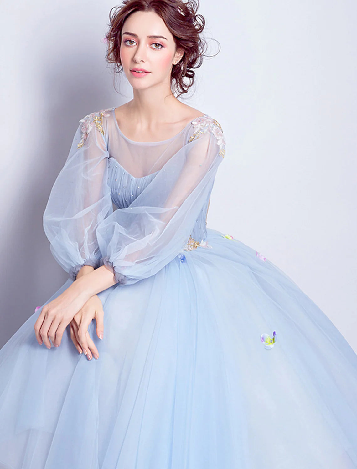 Detail of floral appliques and pleats on the tulle skirt of the ball gown.