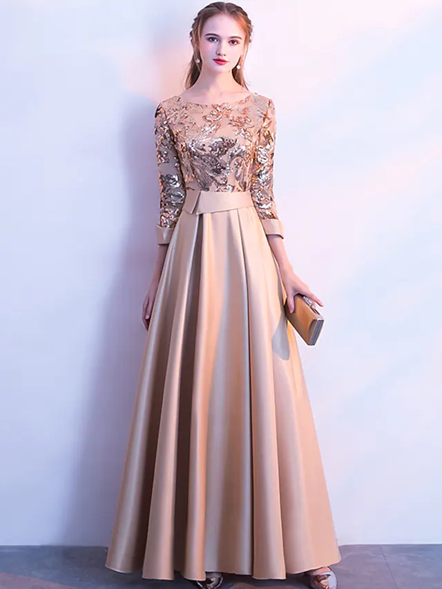 Elegant A-line glittering evening dress with jewel neck and 3/4 sleeves.