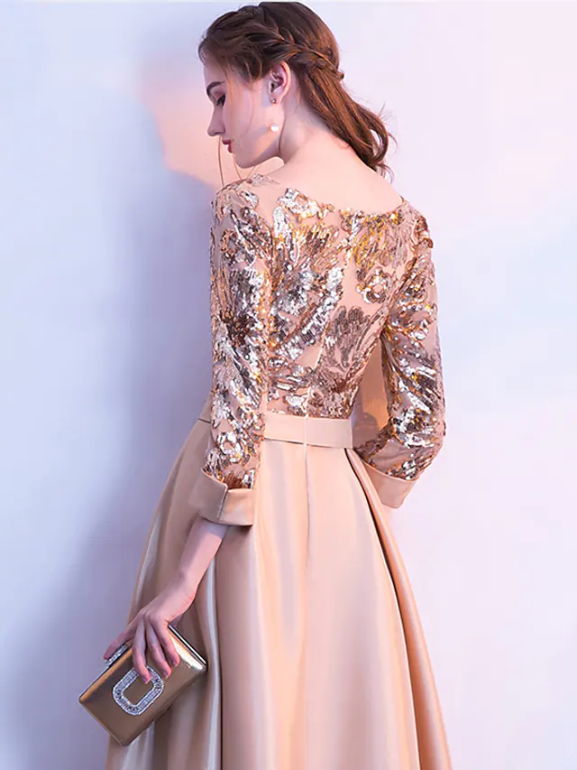 Elegant A-line glittering evening dress with jewel neck and 3/4 sleeves.