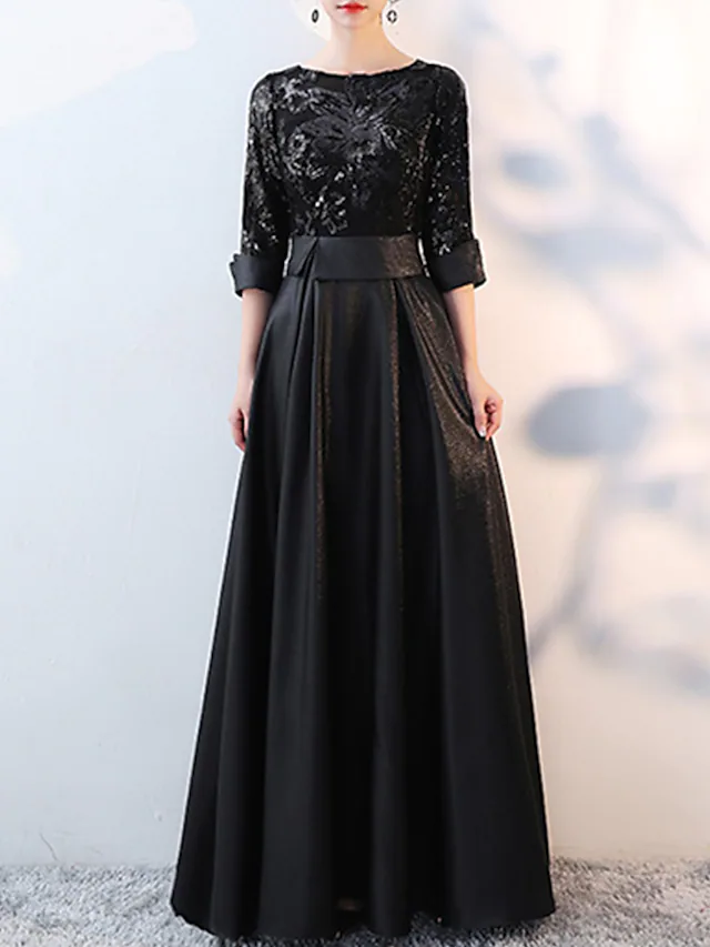 Elegant A-line glittering evening dress with jewel neck and 3/4 sleeves.
