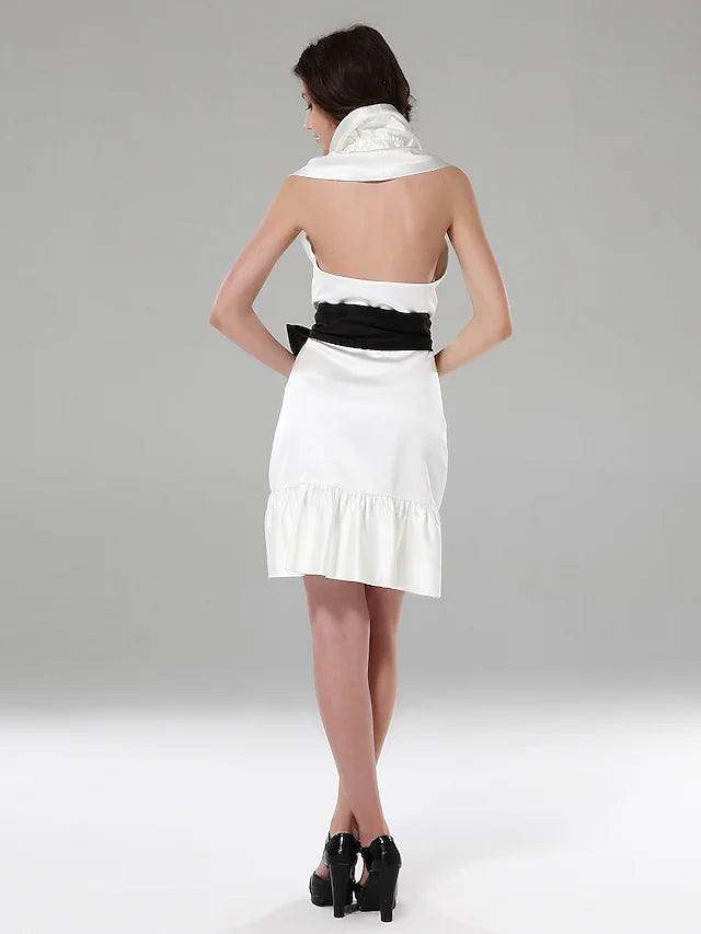 Side view of a blush halter sheath mini dress, highlighting the column silhouette and ruffles.
