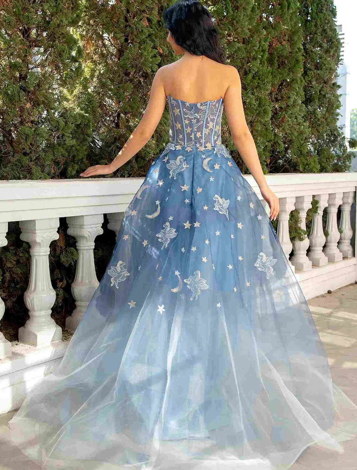 Back view of strapless ivory ball gown with intricate lace and court train.