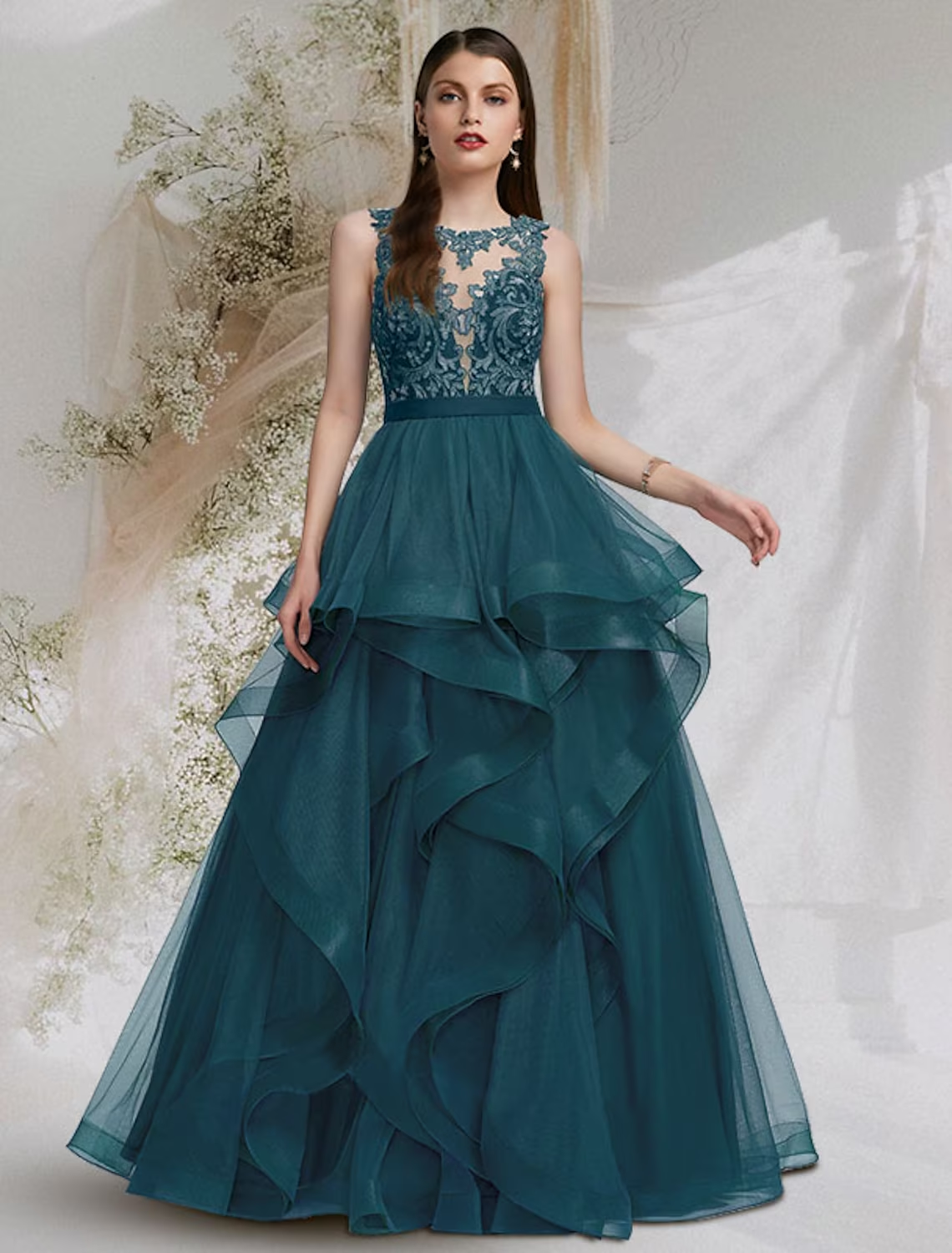 Model wearing an elegant jewel neck ball gown with cut-out details and lace inserts.