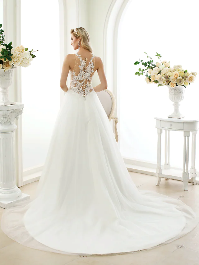 Back view of ball gown wedding dress showing see-through lace and button details.