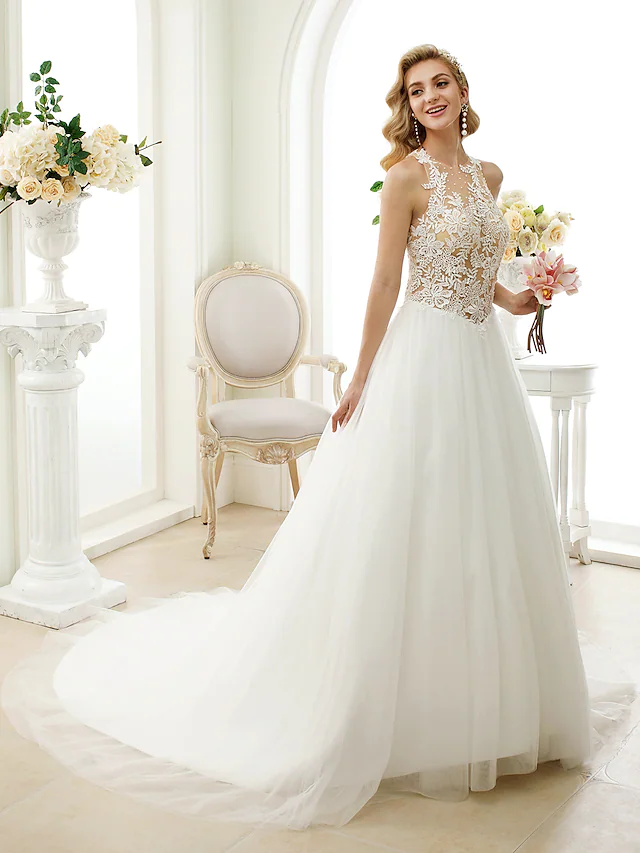 Close-up of lace tulle fabric and appliques on a wedding dress.