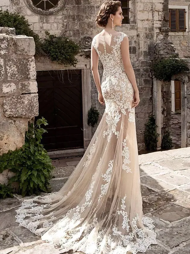 Side view of the court train and lace details on the wedding gown.