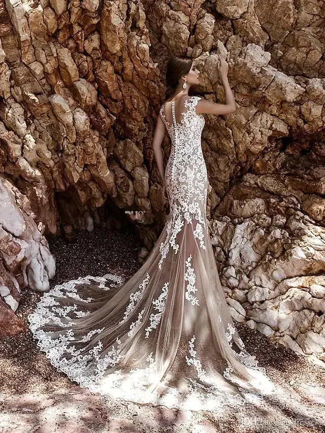 Full length view of the elegant cap sleeve wedding dress.