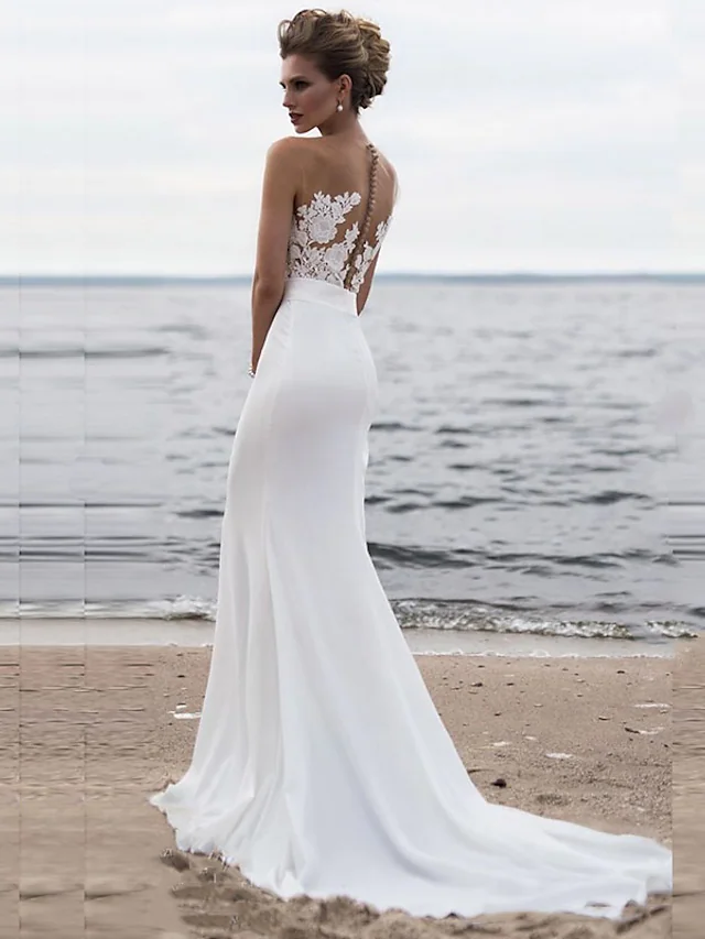 Back view of a modern wedding dress showing chapel train and delicate details.