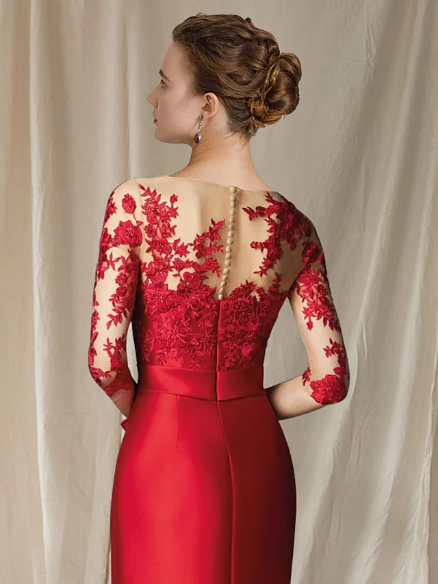 Back view of the floor-length mermaid gown with bow appliques.