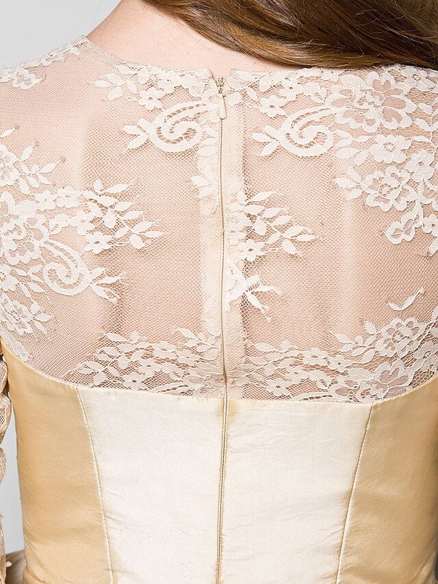 Detail of the 3/4 sleeve and jewel neckline on the formal dress.